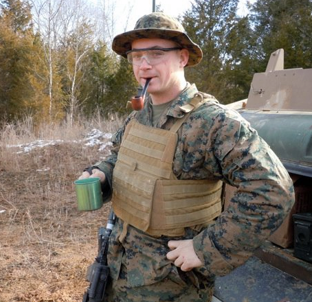 A man in a military uniform with a pipe in his mouth