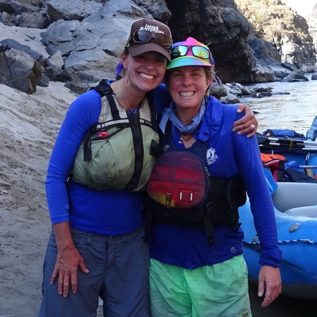Two Women Posing for A Picture with One Wearing a Hat