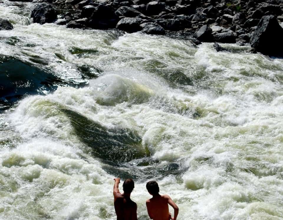 Two People Standing in Middle of A River