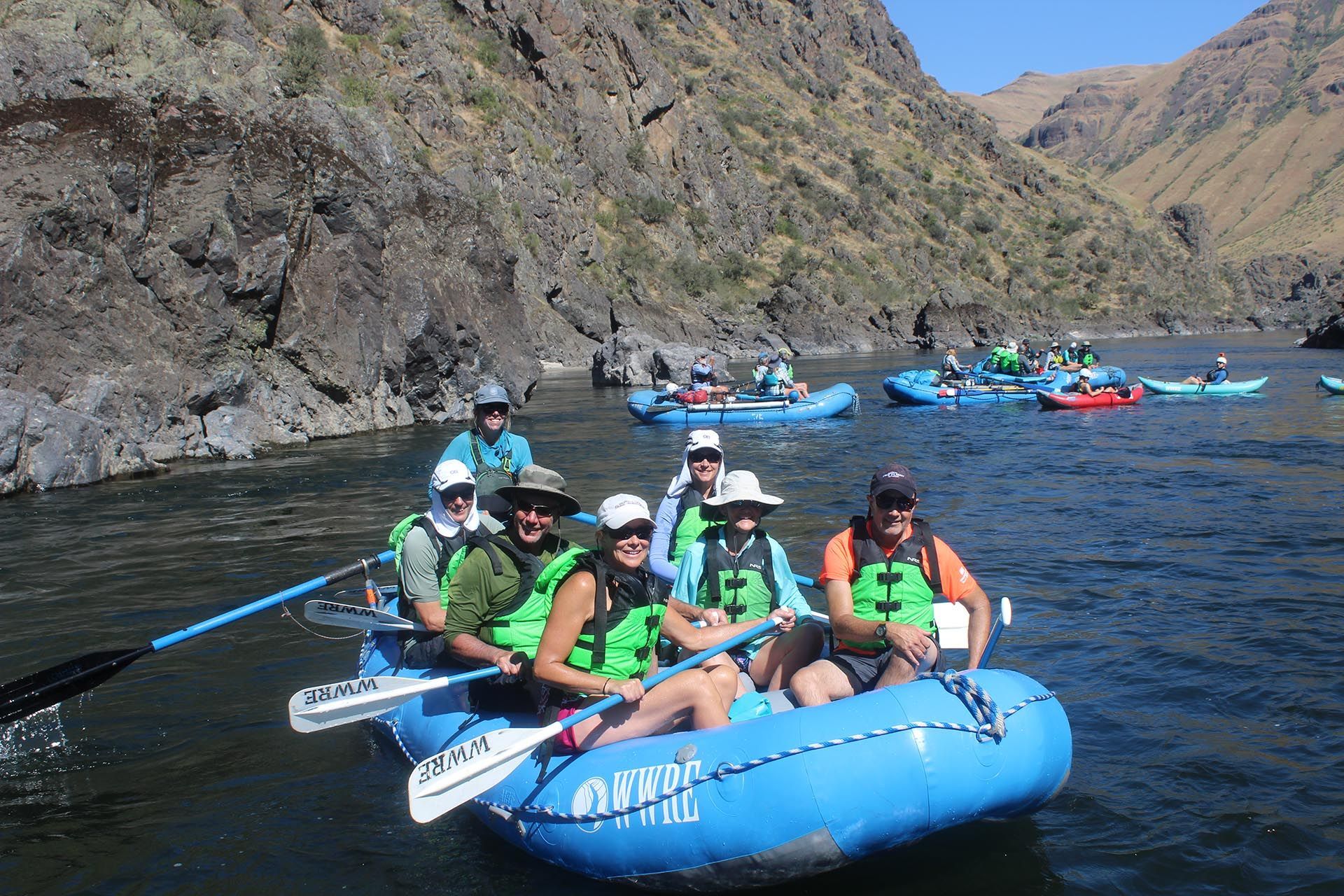 several blue rafts in calm water