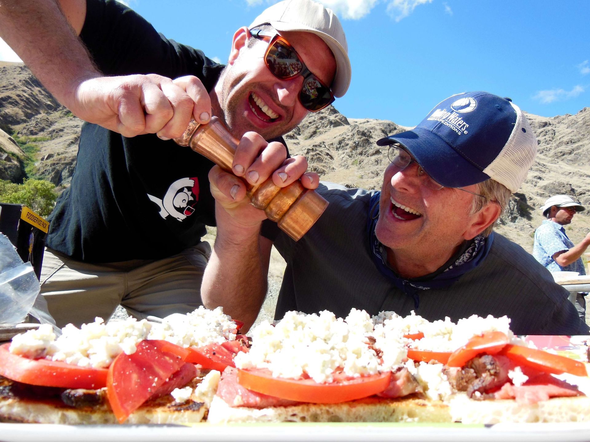 Two Person Adding Seasoning to the Food