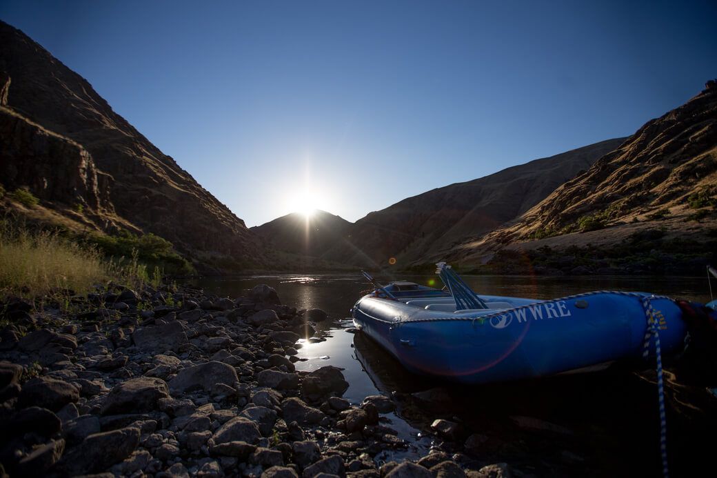 Blue Raft Is Sitting in The Middle of A River