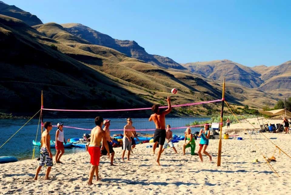 Group of people are playing volleyball on a beach