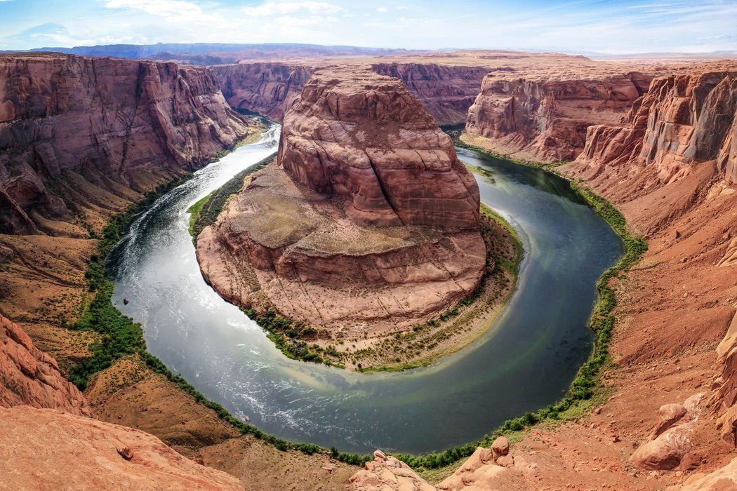 River in The Middle of A Canyon Surrounded by Rocks