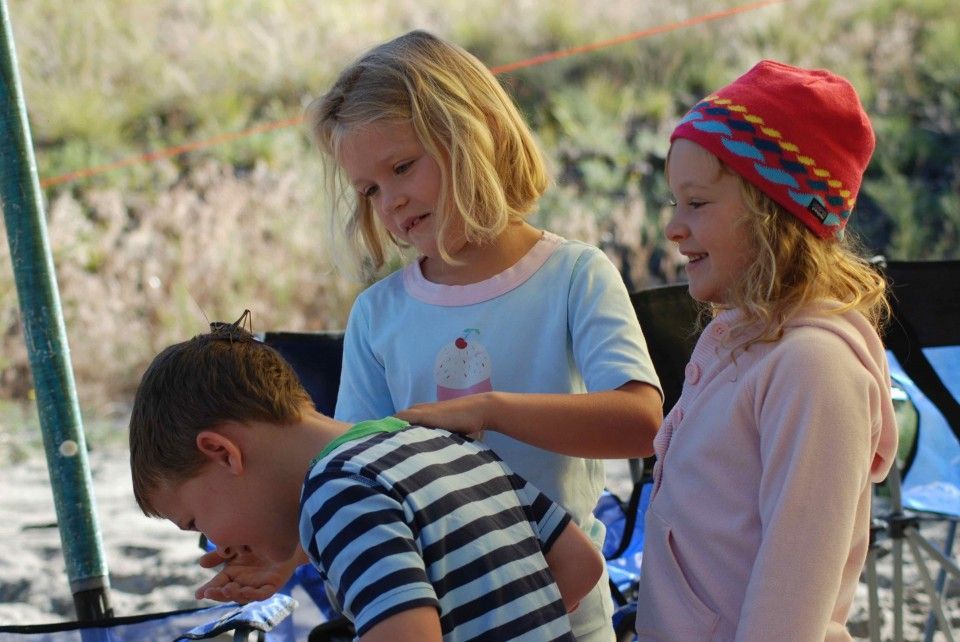 Boy and Two Girls Standing Next to Each Other on A Beach