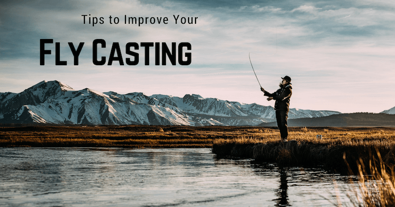 Man Is Fishing in A River with Mountains in The Background