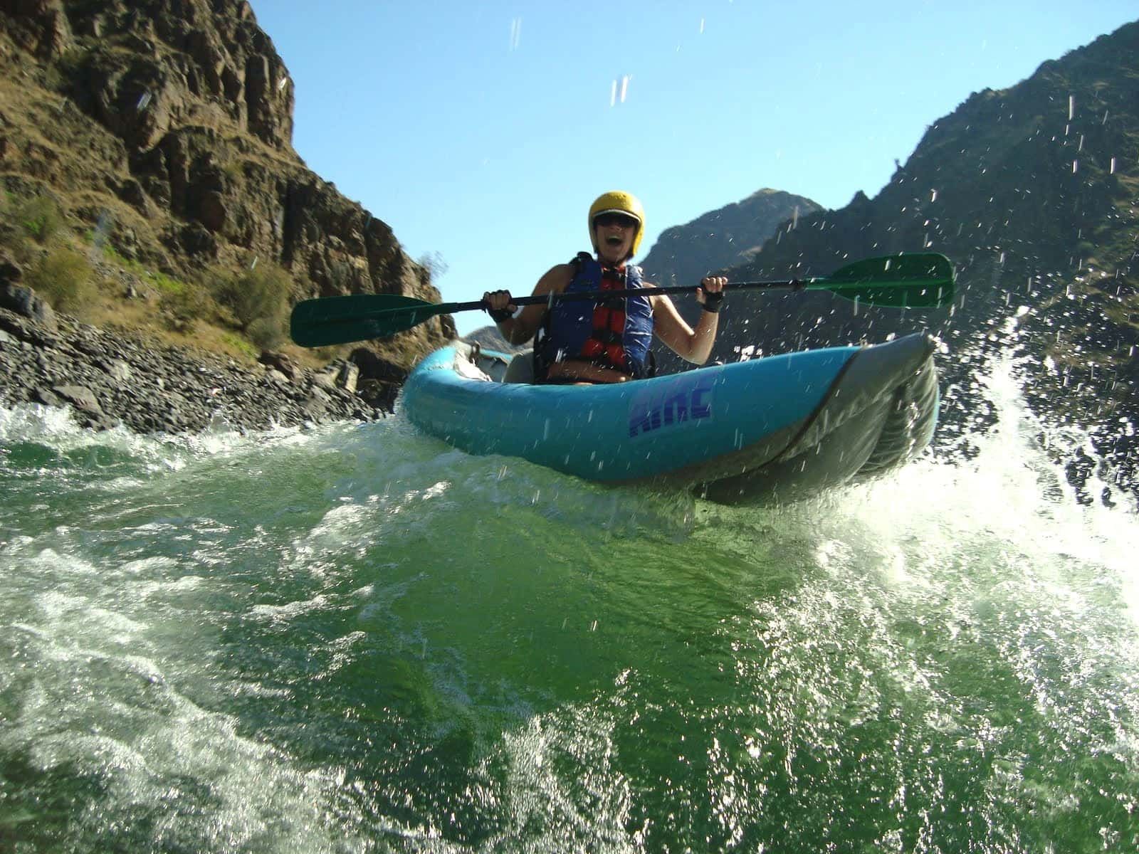 A person in a blue kayak