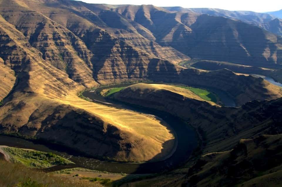 River Flowing Through a Canyon Surrounded by Mountains