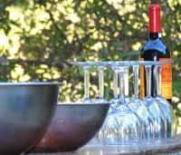 Bottle of Wine Sitting on A Table Next to A Row of Wine Glasses