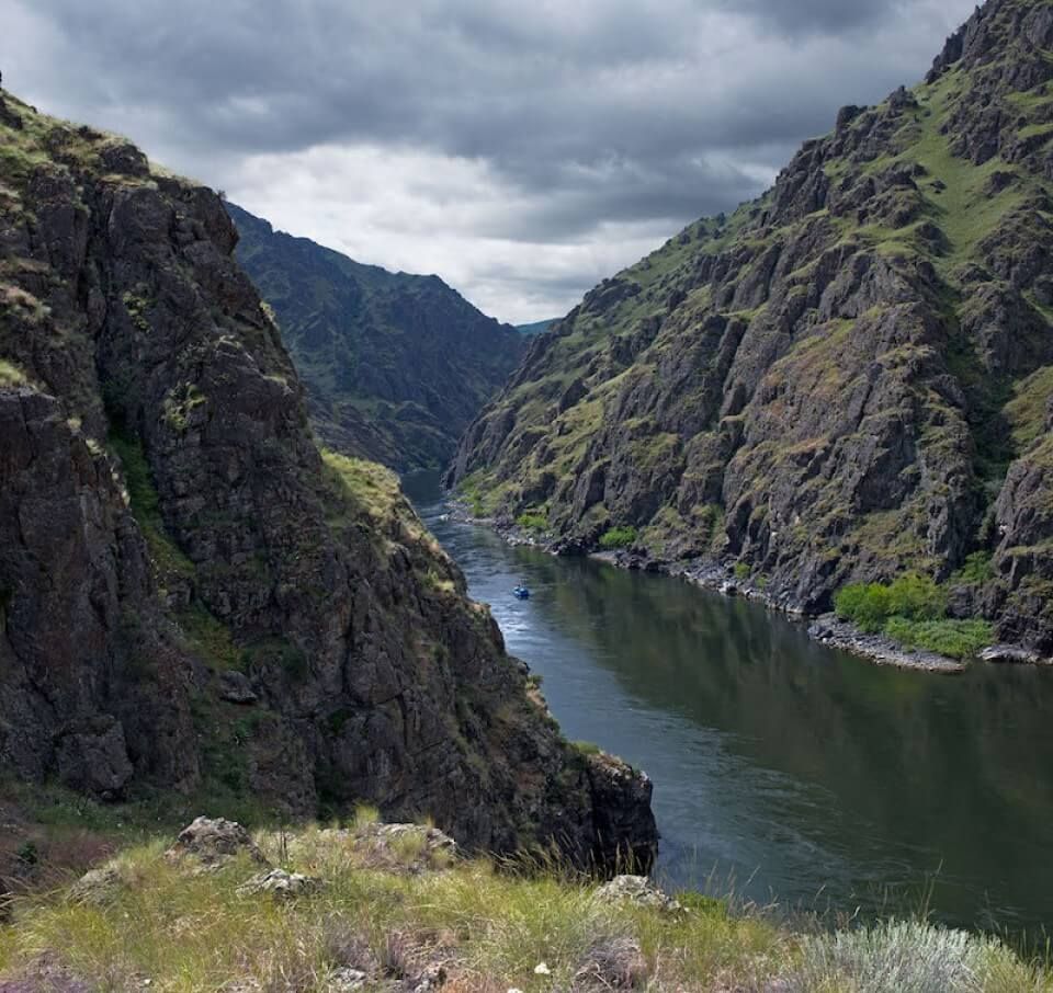 River Runs Through a Canyon Between Two Mountains