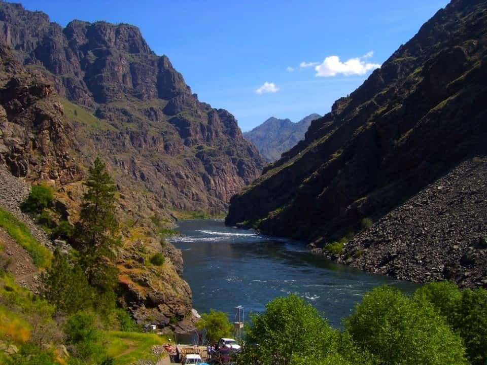 River Running Through a Canyon with Mountains in The Background