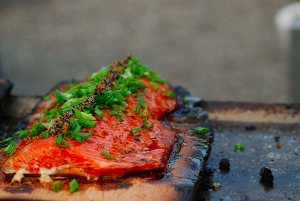 Piece of Salmon Is Sitting on Top of A Wooden Cutting Board