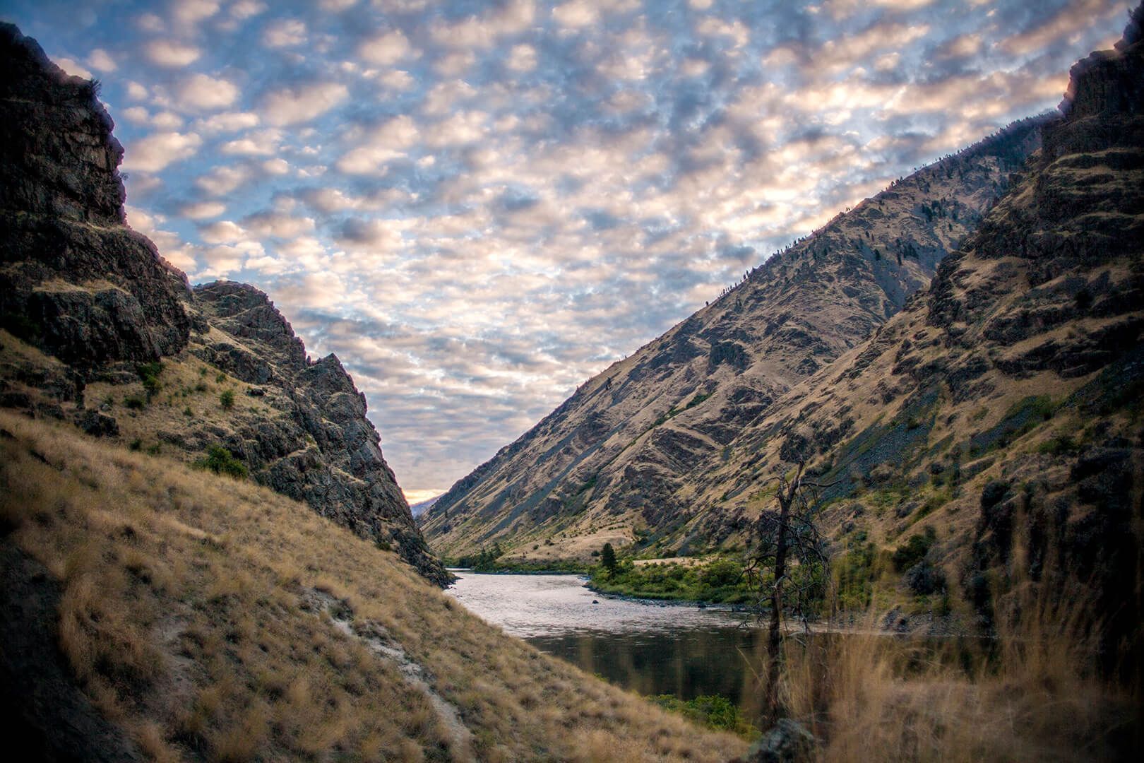 A River Runs Through a Canyon Between Two Mountains