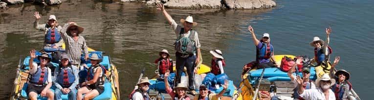 Group of People Are Sitting on Rafts in Water