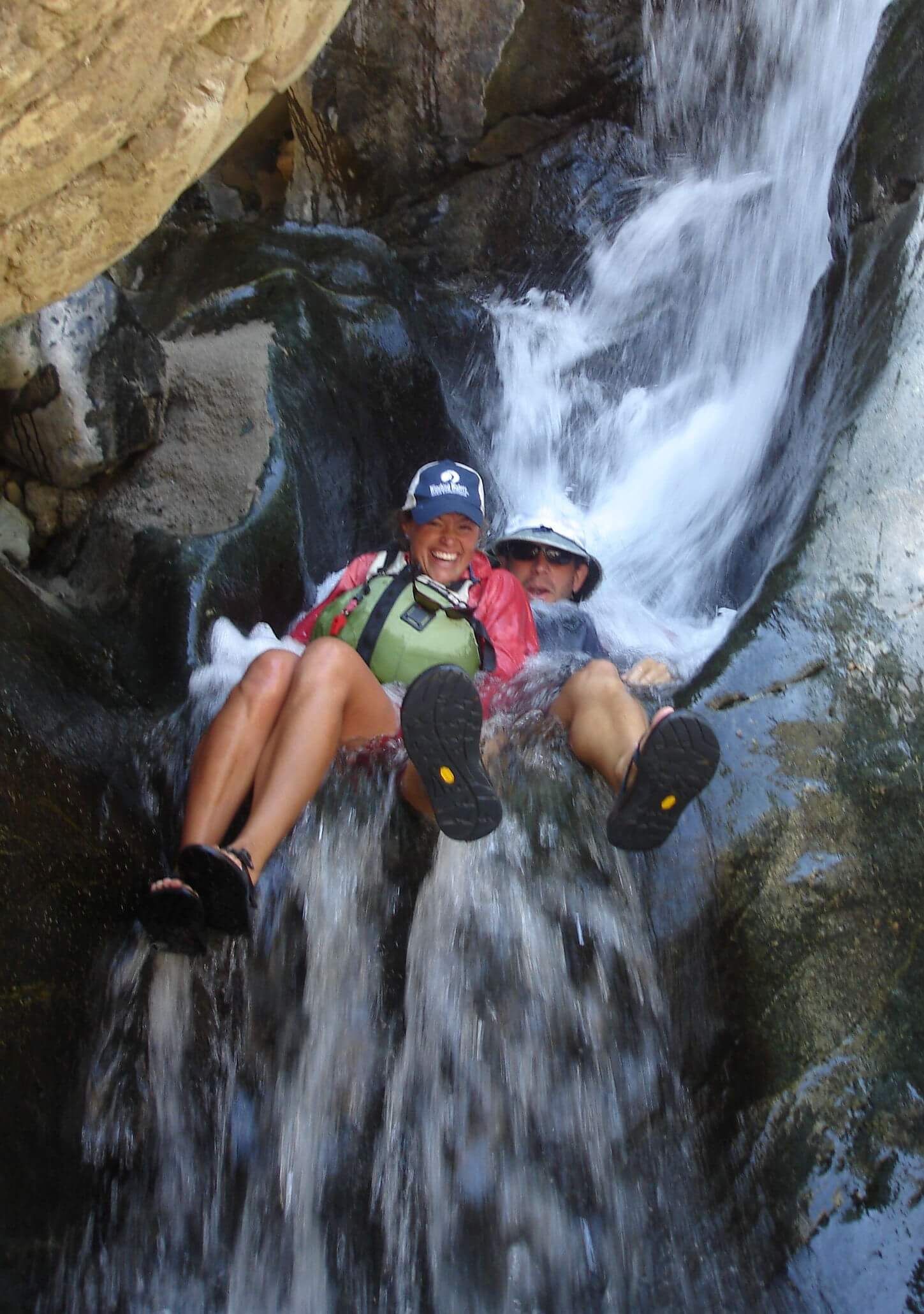 Couple Sitting on A Rock in A Waterfall