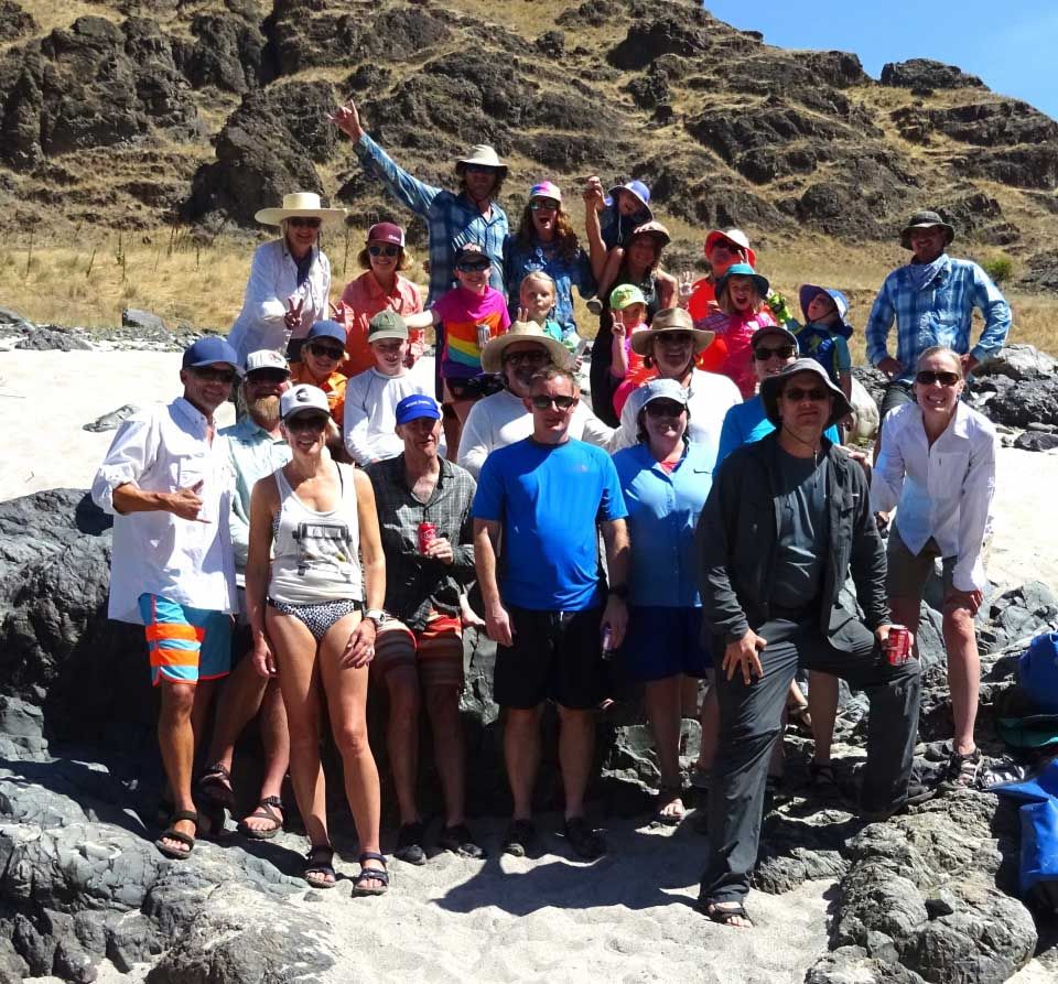 Group of People Posing for A Picture on A Rocky Beach