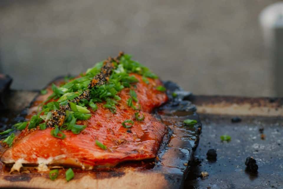 Piece of Salmon with Green Onions on A Wooden Cutting Board