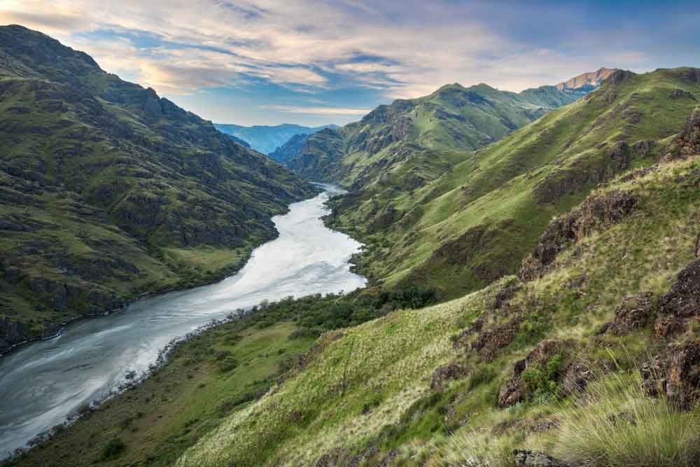 A river runs through a valley between two mountains.