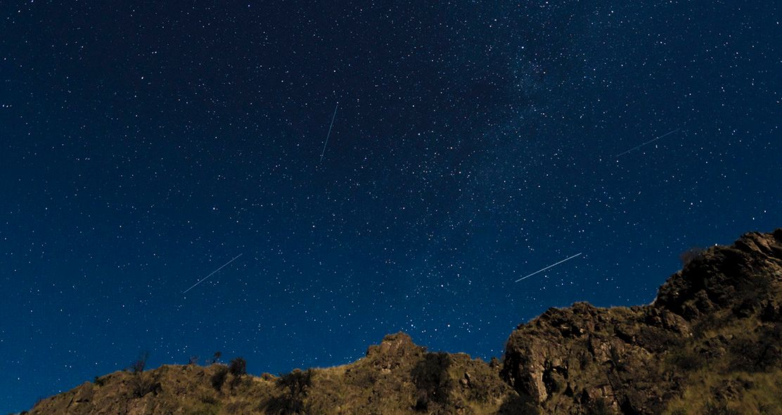 Night Sky Filled with Lots of Stars Over a Mountains