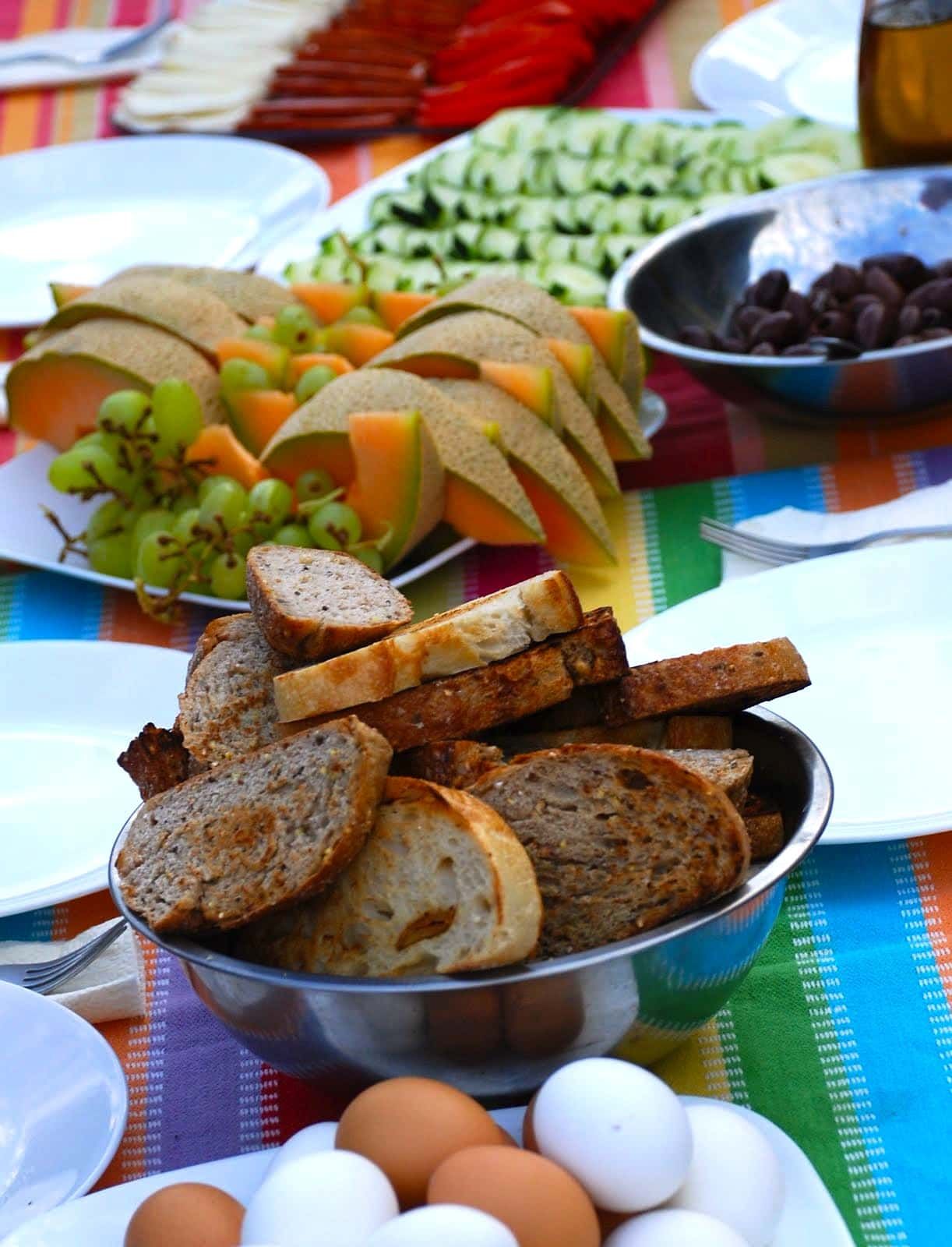 Bowl of bread sits on a table next to eggs