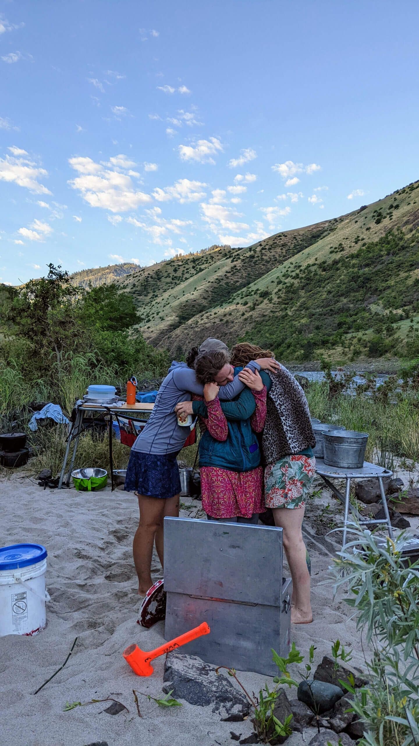 Group of People Are Hugging Each Other in Front of A Mountain