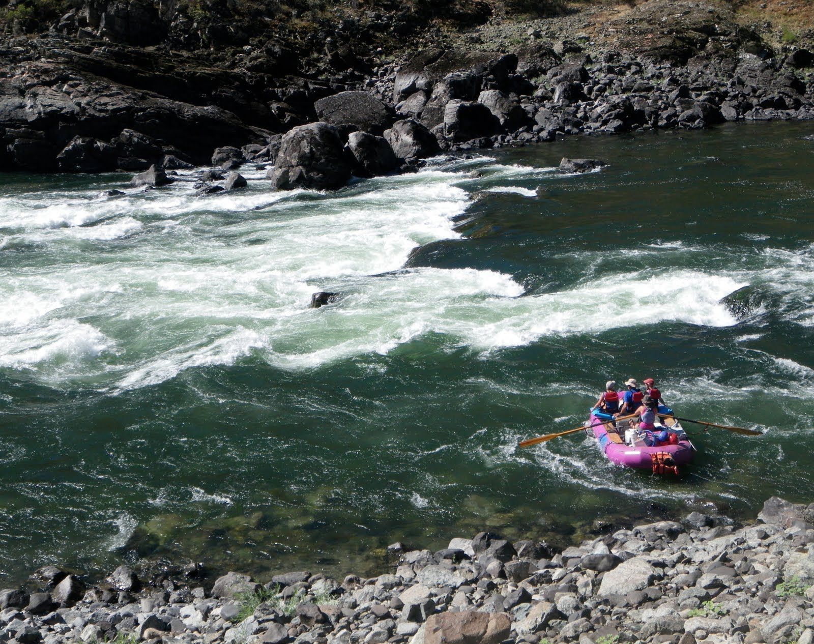 A group of people are rafting down a river
