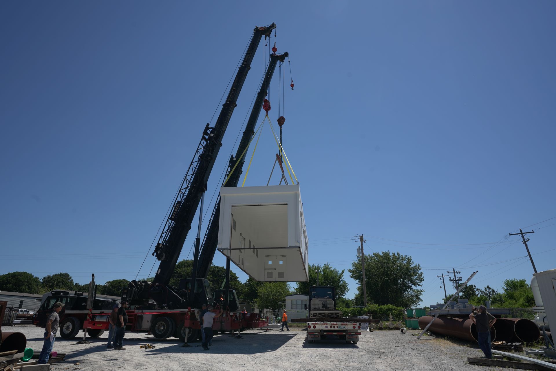 A crane is lifting a building into the air PEI