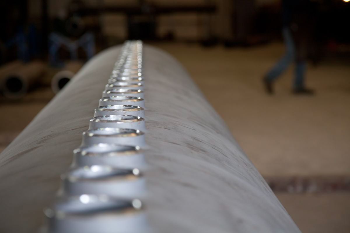 A pipe with multiple extruded outlets in the Pipeline Equipment, Inc. Extrusion facility.