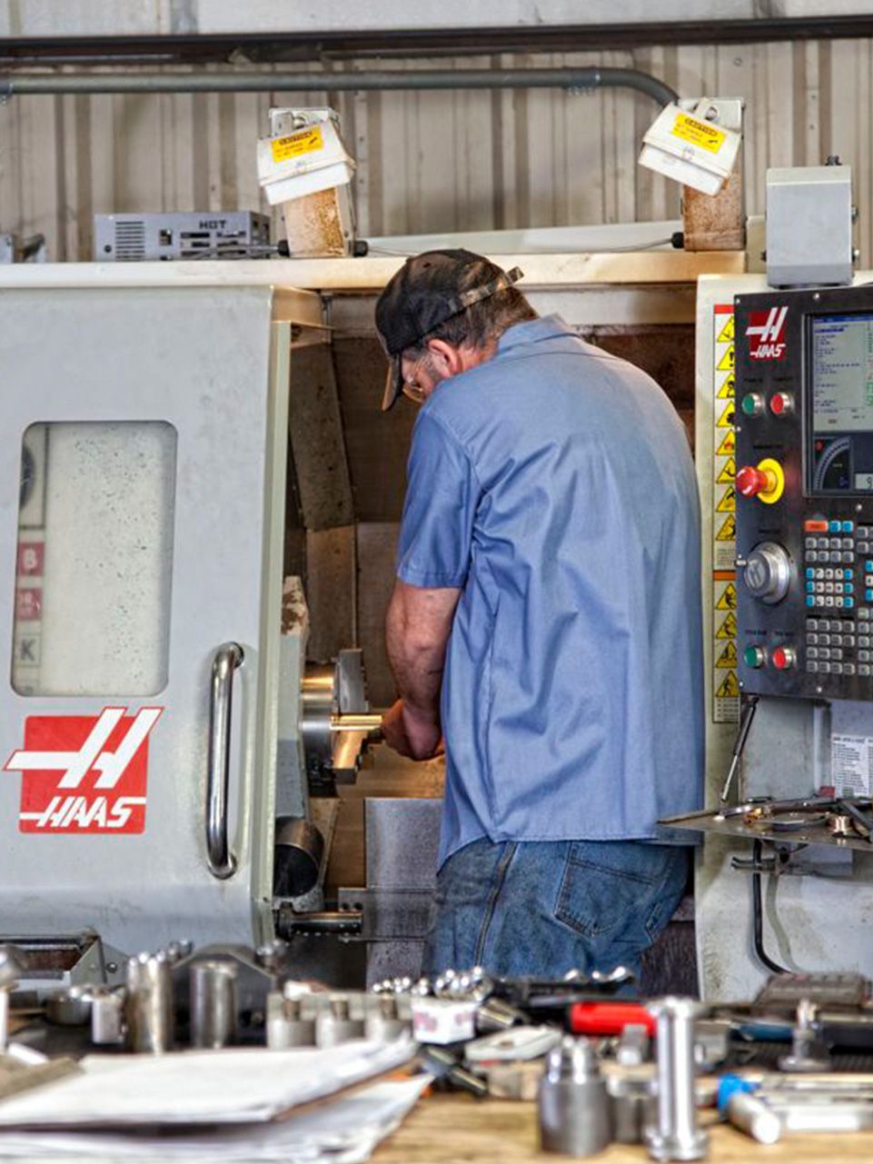 A man is working on a machine in a factory.