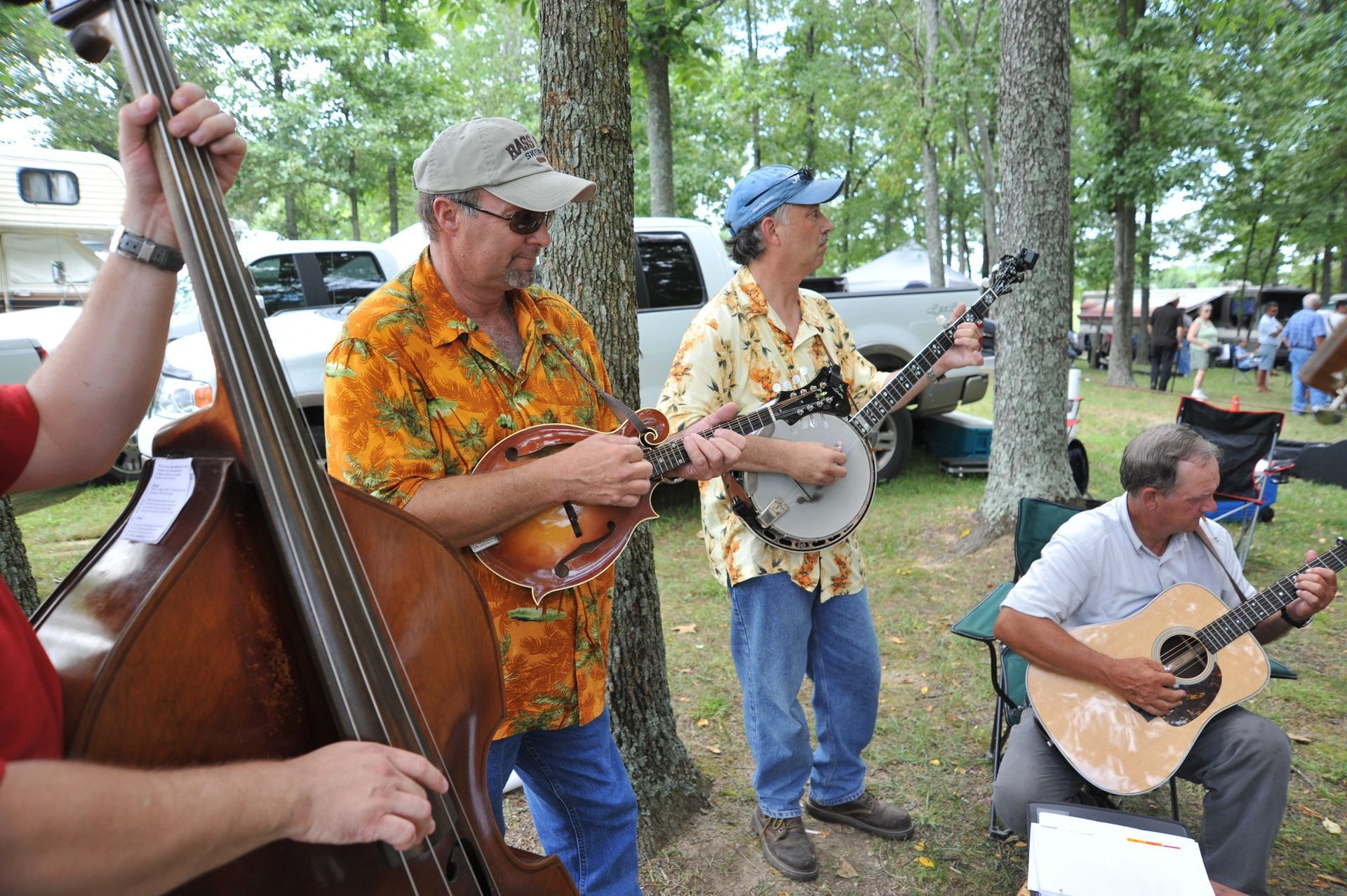 A group of men are playing musical instruments in a park.