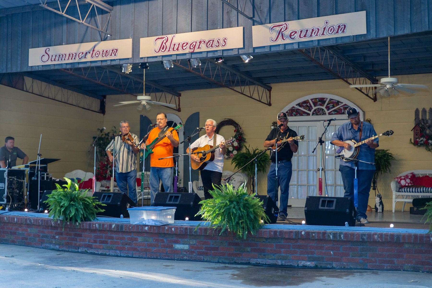 A group of men are playing instruments on a stage.