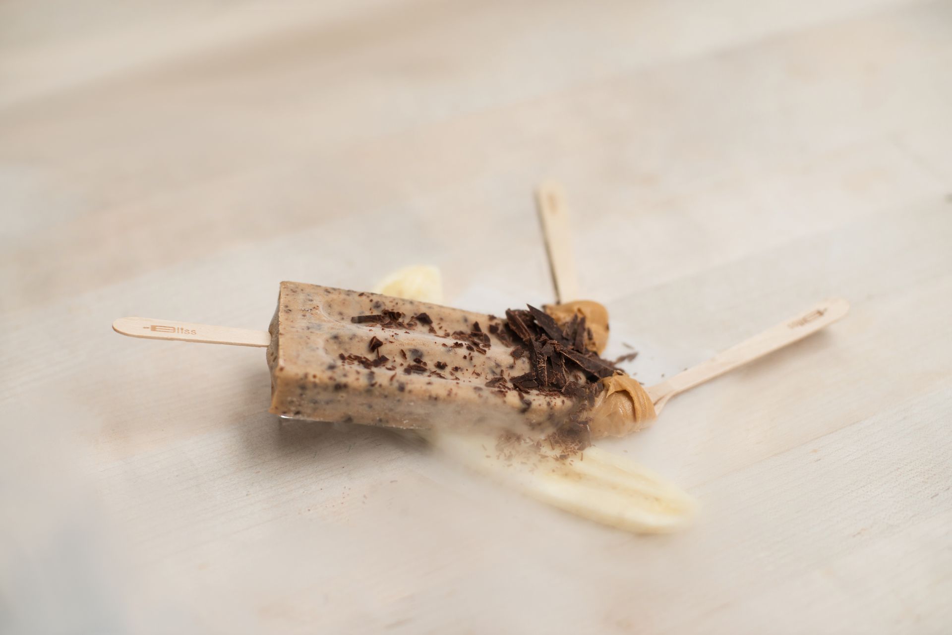 A close up of a popsicle on a stick on a table.