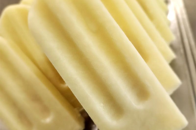 A close up of a white ice cream bar on a table.