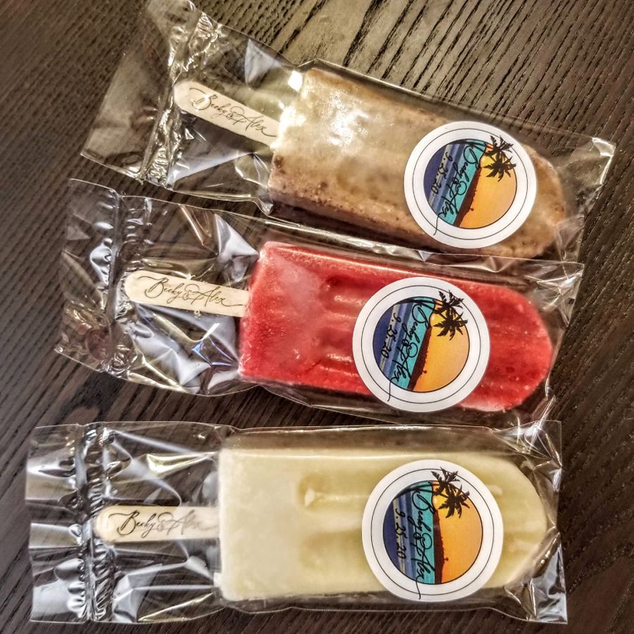 Three different flavors of popsicles are wrapped in plastic