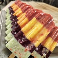 A row of ice pops with different flavors on them