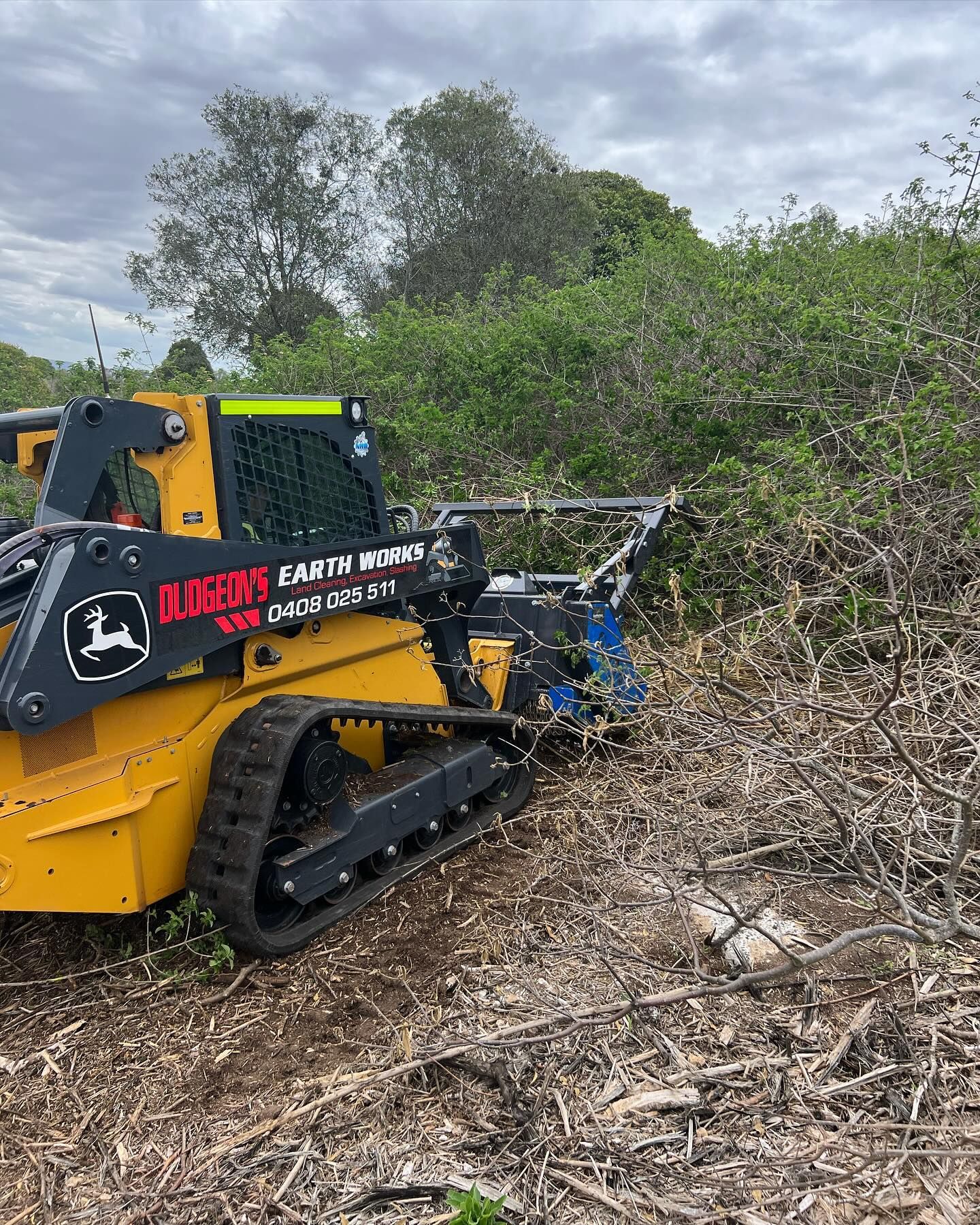 Yellow John Deere Skid Steer Clearing Brush — Dudgeon’s Earthworks in Murgon, QLD