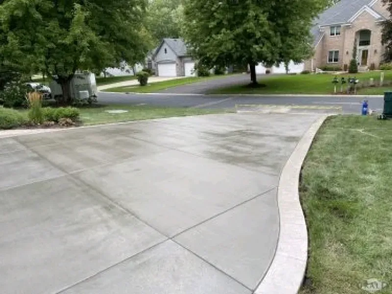 Newly poured concrete driveway with decorative border.
