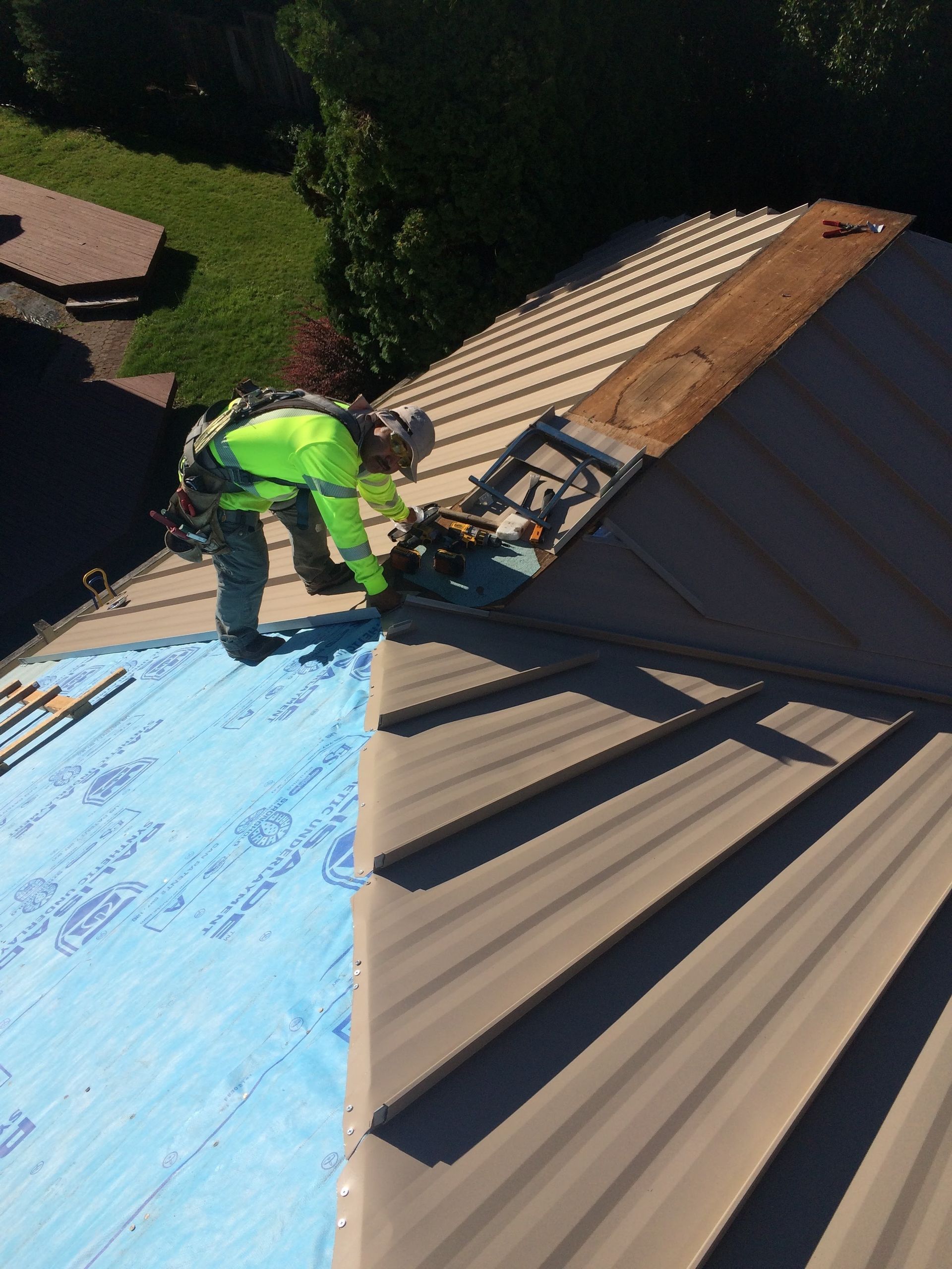 A man is working on the roof of a house