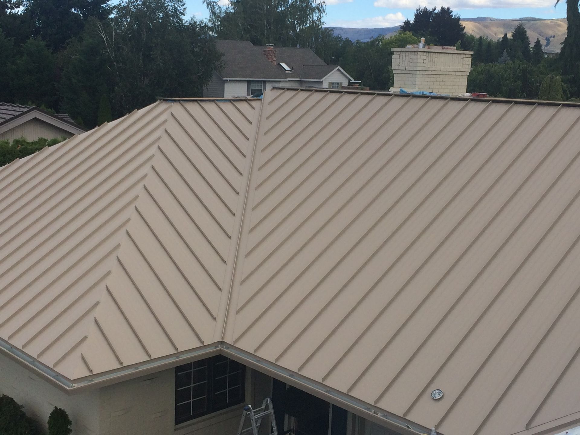 An aerial view of a house with a metal roof.