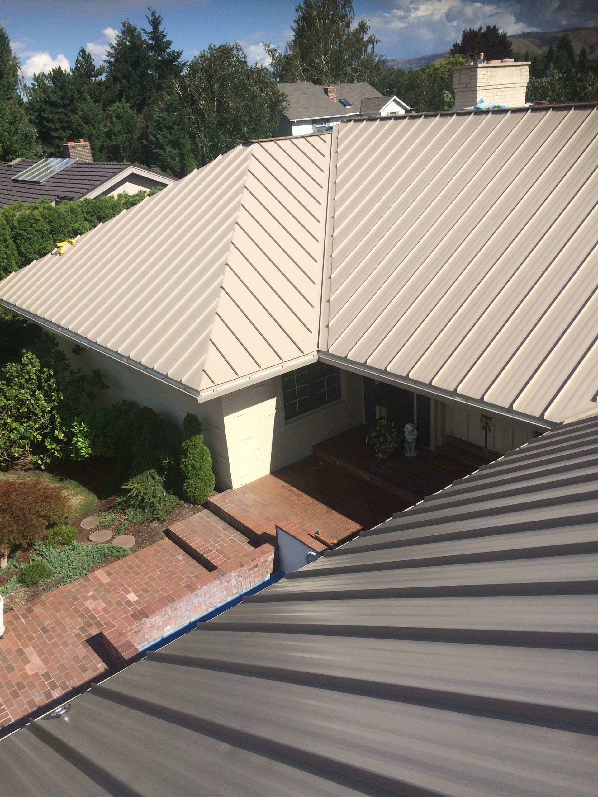 An aerial view of a house with a metal roof.