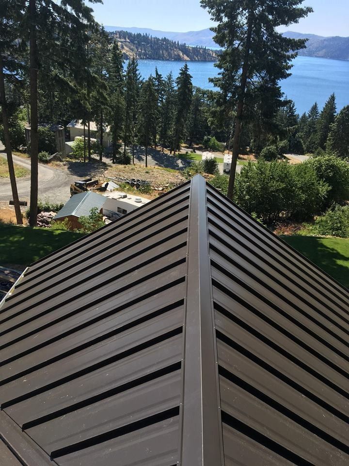 A roof with a view of a lake and trees