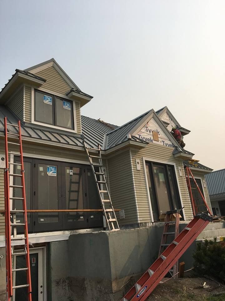 A house with a ladder on the side of it