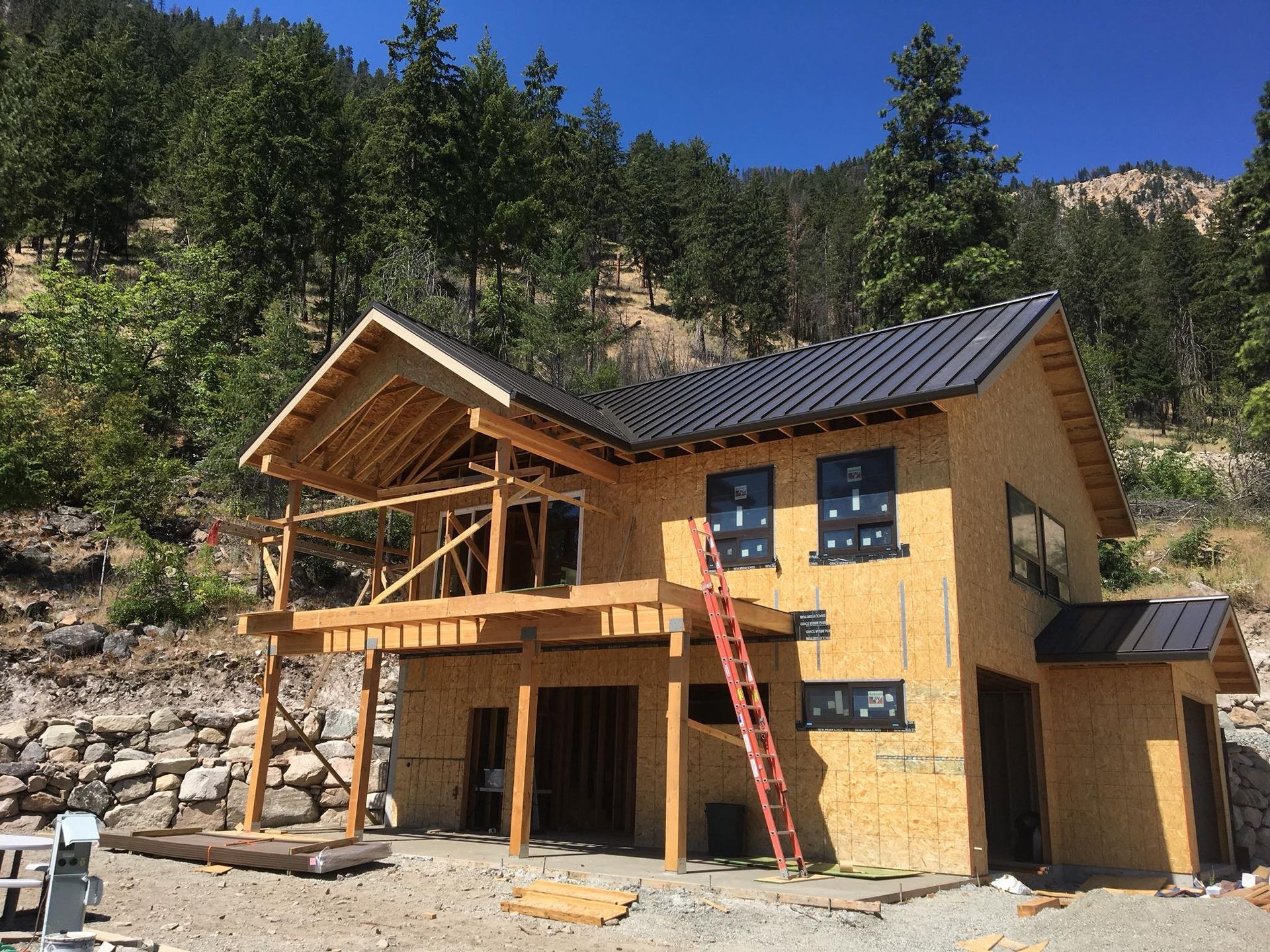 A wooden house is being built in the middle of a forest.