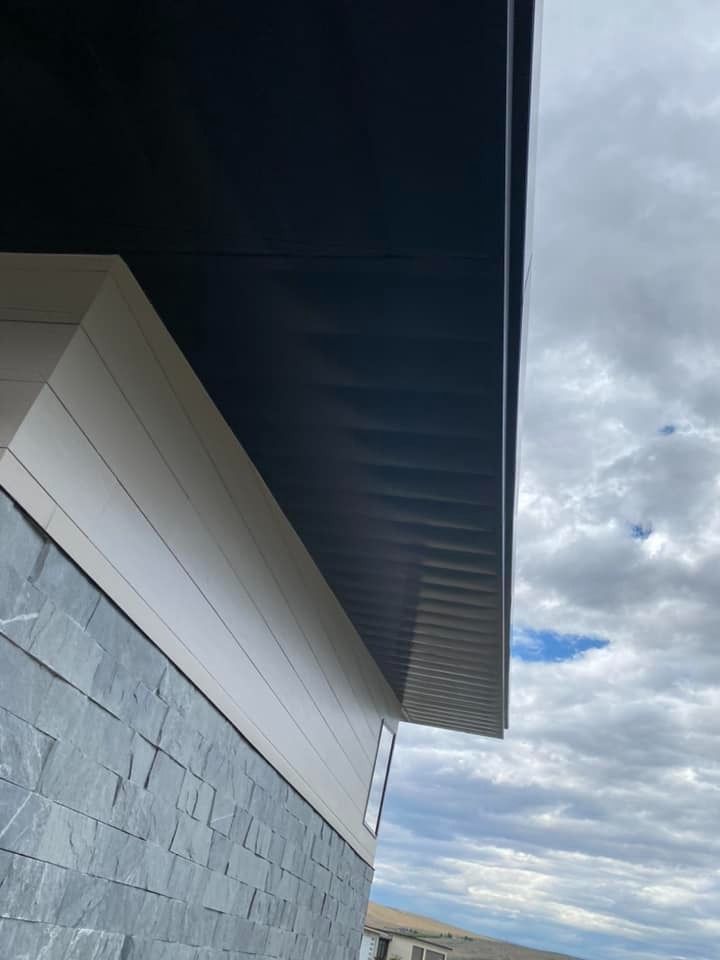 The roof of a house with a cloudy sky in the background
