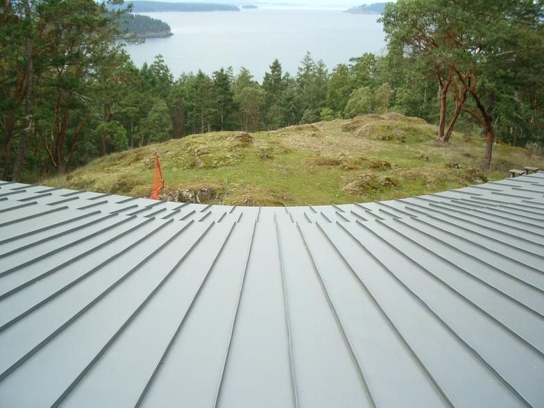 A roof with a view of a lake and trees