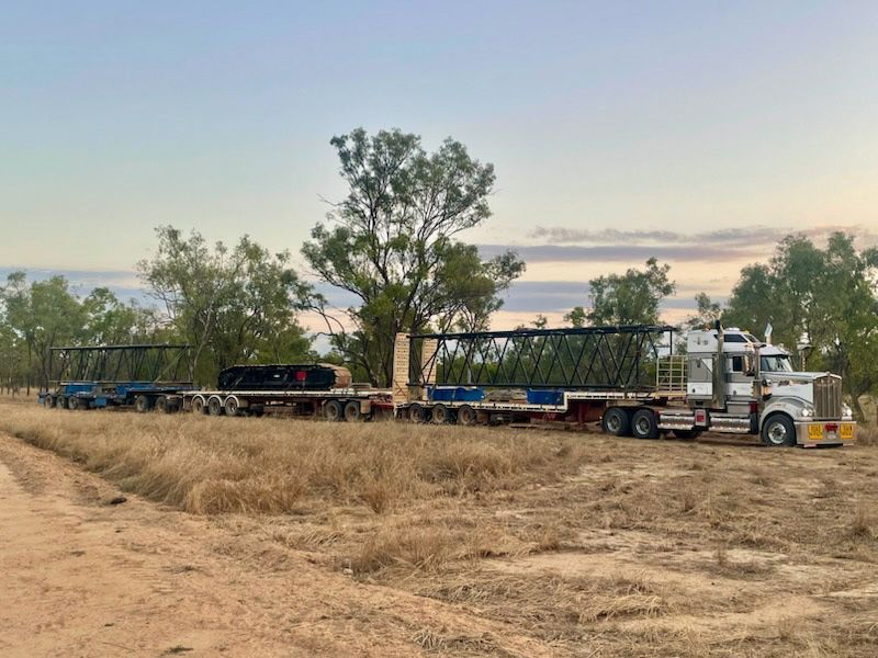 A Semi-truck With A Long Trailer Hauling Large Metal Structures — ECC Heavy Haulage in Brisbane, QLD