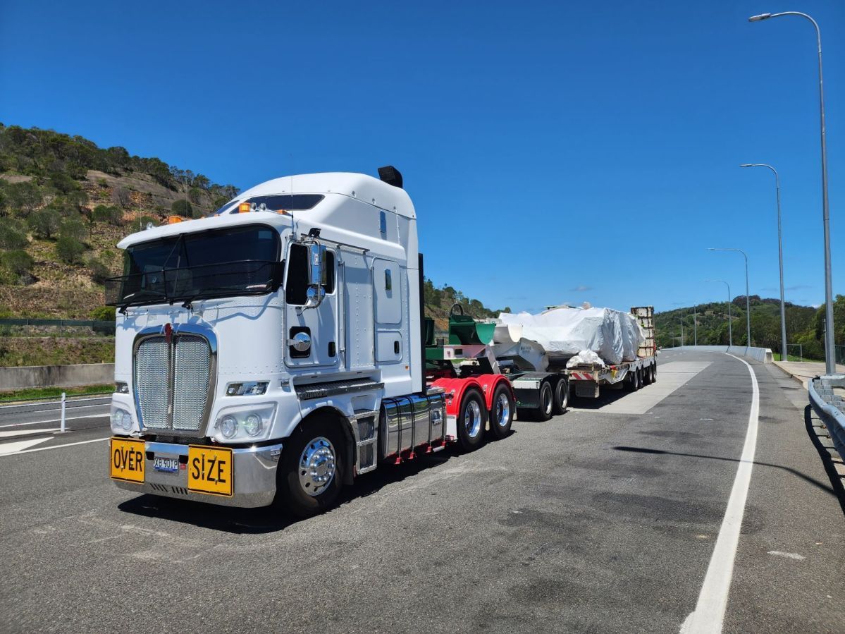 White Semi-truck Hauling A Large Covered Item — ECC Heavy Haulage in Brisbane, QLD