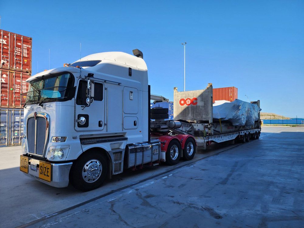 White Semi-truck Pulling A Low-Loader — ECC Heavy Haulage in Cairns, QLD