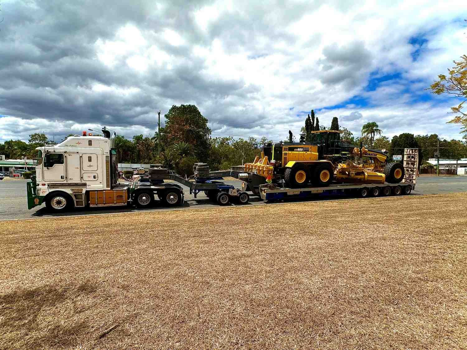 Semi-Truck Transporting Large Yellow Construction Equipment — ECC Heavy Haulage in Ormeau, QLD