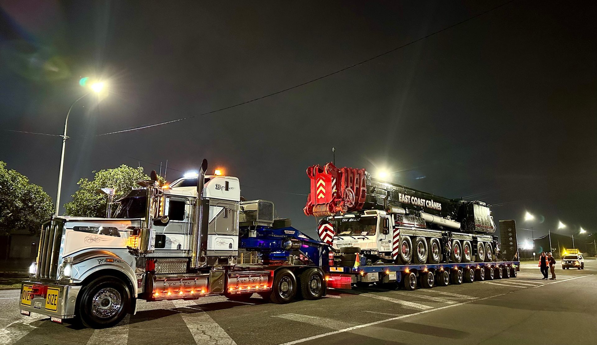 Heavy Transport Truck Carrying a Crane at Night on a Road — ECC Heavy Haulage in Ormeau, QLD